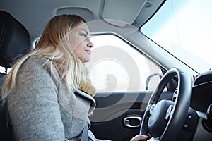 Young adult woman driving car on highway during day time