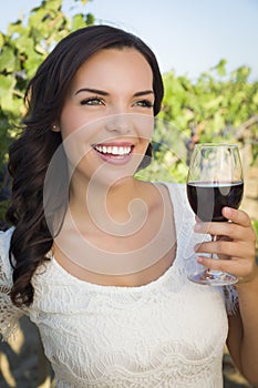 Young Adult Woman Enjoying A Glass of Wine in Vineyard