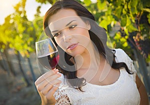 Young Adult Woman Enjoying A Glass of Wine in Vineyard