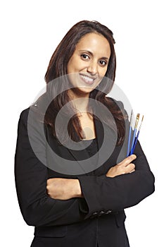 Young adult woman face painter with paint brushes