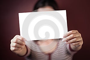 Young adult woman holding a blank sign