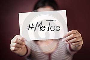 Young woman holding a sign with the hashtag MeToo photo