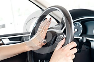 Young adult woman honking at traffic jam