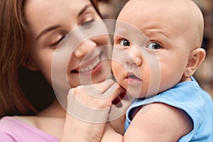 Young adult woman looking at her little newborn offspring