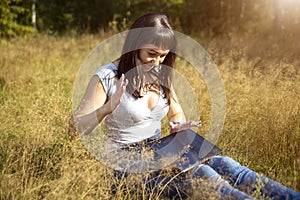 Young adult woman looks at a laptop in a panic and holds her head. network problems