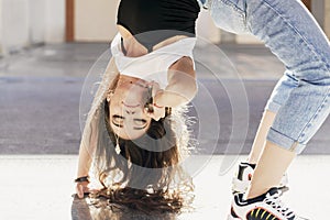 Young adult woman of short section dancing stretching her body on the floor while talking on the mobile phone