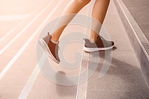 Young adult woman walking up the stairs