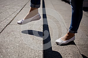 Young adult woman walking up the stairs.