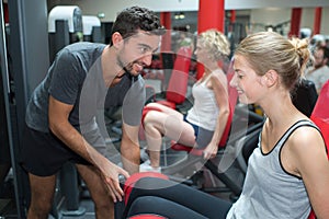 Young adult woman working out with personal trainer