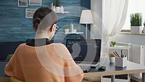 Young adult working on binary code programming at desk