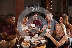 Young adults eating Chinese take-away at a party at home