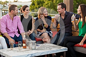 Young adults having drinks at a bar