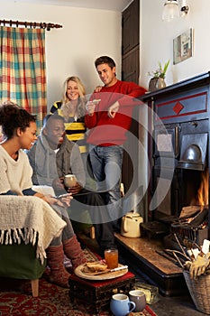 Young adults making toast on open fire