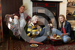 Young adults making toast on open fire