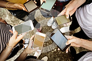 Young adults using smartphones in a circle social media and conn