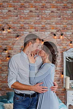 Young affectionate couple kissing tenderly in studio