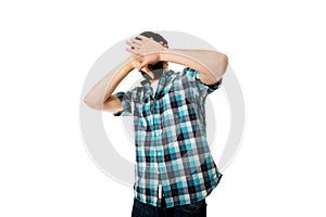 Young afraid man covering his face.