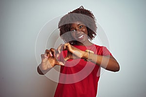 Young african afro woman wearing red t-shirt over isolated white background smiling in love showing heart symbol and shape with