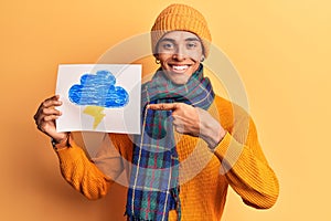 Young african amercian man holding thunder draw smiling happy pointing with hand and finger