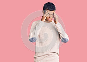 Young african amercian man wearing casual clothes with hand on head for pain in head because stress