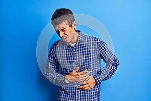 Young african amercian man wearing casual clothes with hand on stomach because nausea, painful disease feeling unwell