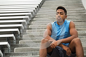 Young African Amerian teenage athlete thinking about his future.