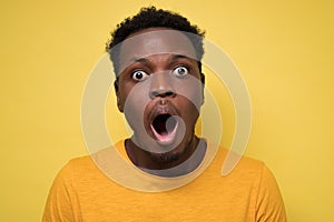 Young african american black man surprised face expression