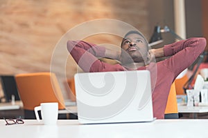 Young African-American business man taking a break at his desk