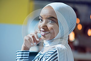 Young African American business woman sitting at her desk and smiling