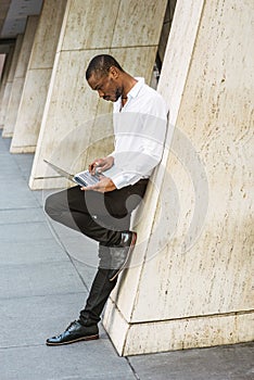 Young African American businessman with beard working in New York