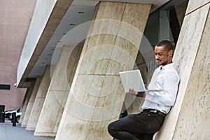 Young African American businessman with beard working in New York