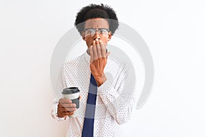 Young african american businessman drinking cup of coffee over isolated white background cover mouth with hand shocked with shame