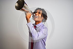 Young african american businessman screaming using vintage megaphone