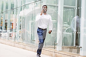 Young African American businessman talking on cell phone, travel