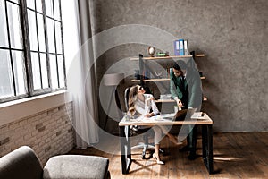 Young african american businessman using computer laptop with his with a female colleague at the office