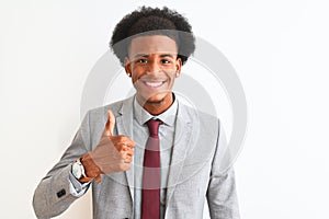 Young african american businessman wearing suit standing over isolated white background doing happy thumbs up gesture with hand