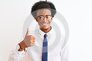 Young african american businessman wearing tie and glasses over isolated white background doing happy thumbs up gesture with hand