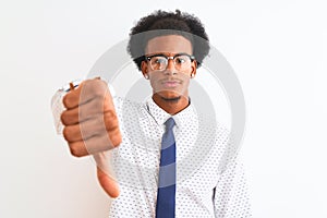 Young african american businessman wearing tie and glasses over isolated white background looking unhappy and angry showing