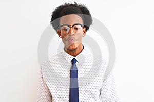 Young african american businessman wearing tie and glasses over isolated white background making fish face with lips, crazy and