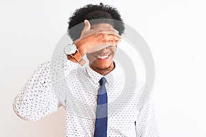 Young african american businessman wearing tie and glasses over isolated white background smiling and laughing with hand on face