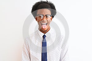 Young african american businessman wearing tie and glasses over isolated white background sticking tongue out happy with funny