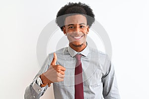 Young african american businessman wearing tie standing over isolated white background doing happy thumbs up gesture with hand