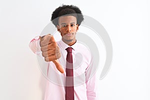 Young african american businessman wearing tie standing over isolated white background looking unhappy and angry showing rejection