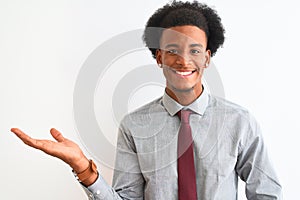 Young african american businessman wearing tie standing over isolated white background smiling cheerful presenting and pointing