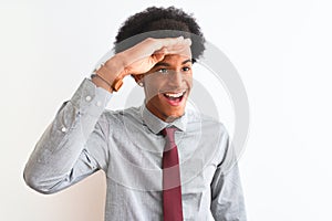 Young african american businessman wearing tie standing over isolated white background very happy and smiling looking far away