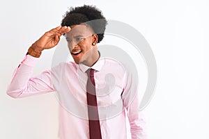 Young african american businessman wearing tie standing over isolated white background very happy and smiling looking far away
