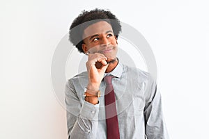 Young african american businessman wearing tie standing over  white background with hand on chin thinking about question,