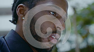 Young African-American businessman working with a laptop on the street closeup shot