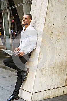 Young African American businessman with beard working in New York