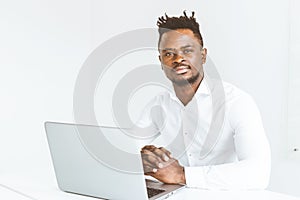 Young african American businessman working in the office at the laptop